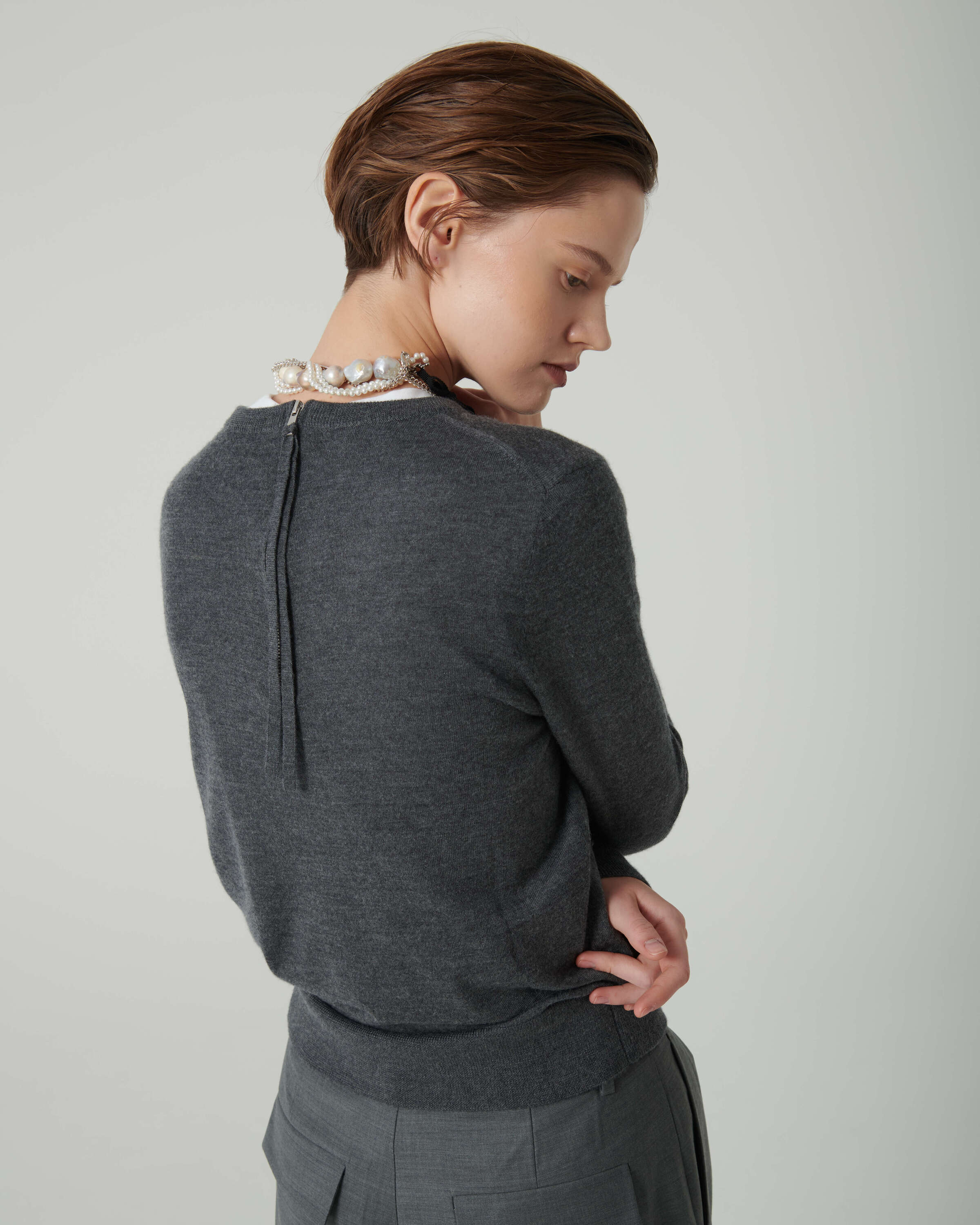deep grey sweater with zip on the back